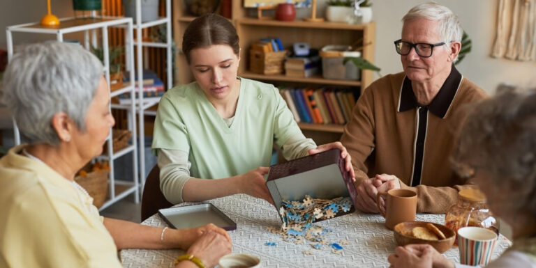 Skilled Nurse Sharing Puzzle Activity at Memory Care Facility